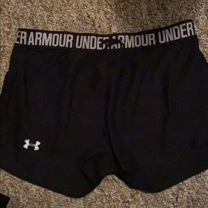 small black under armor running shorts.